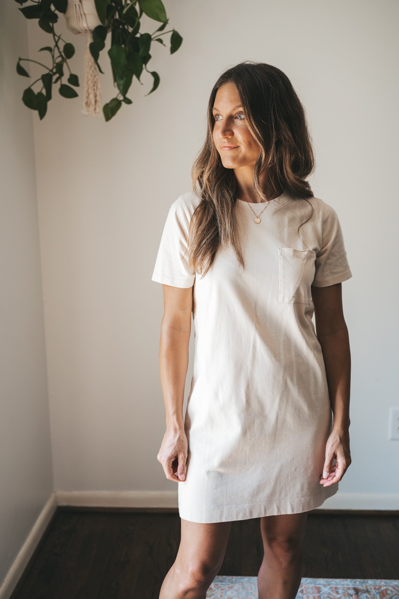 ashley wearing a cream colored t-shirt dress