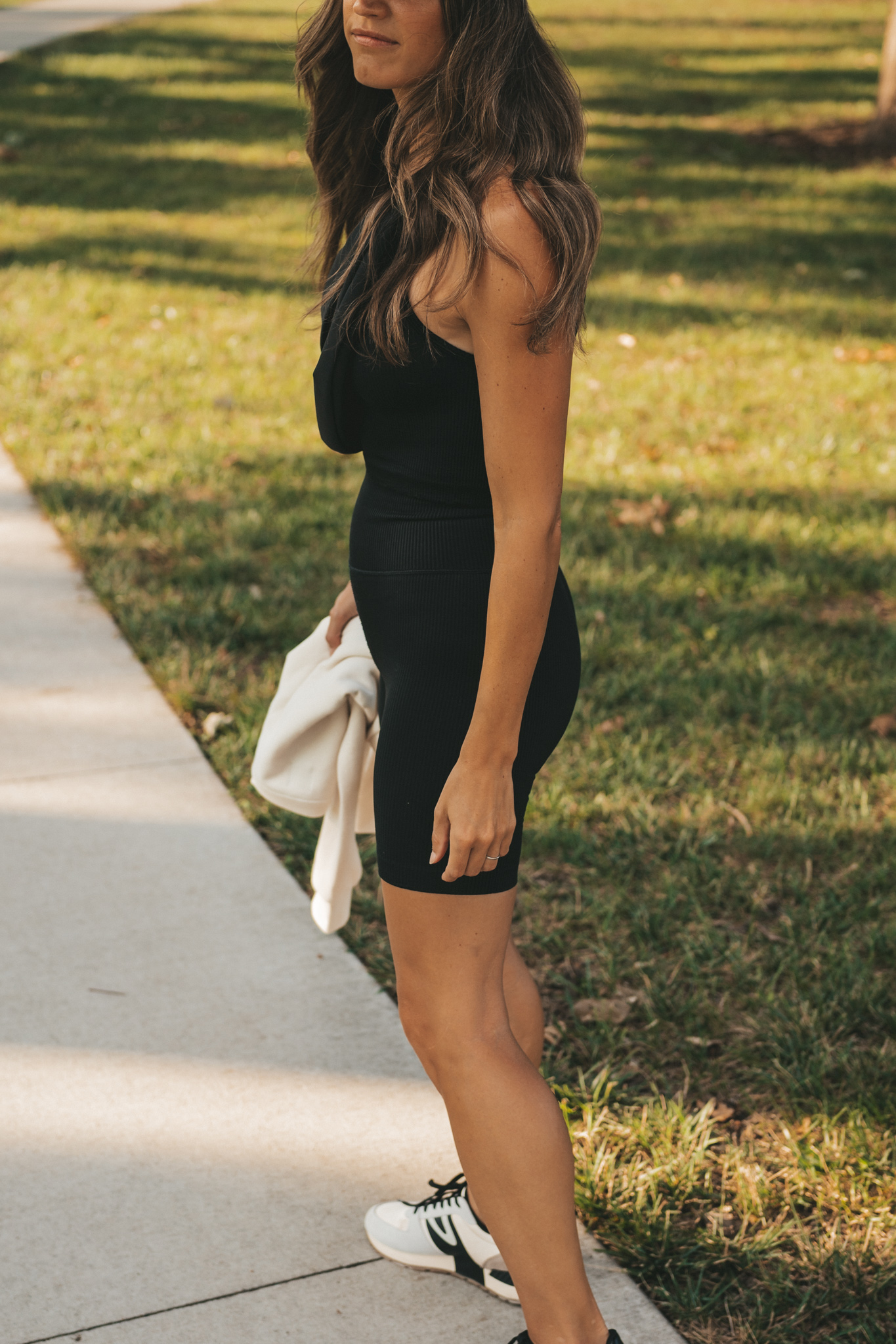 ashley wearing a ribbed cropped tank, ribbed biker shorts, and a black belt bag