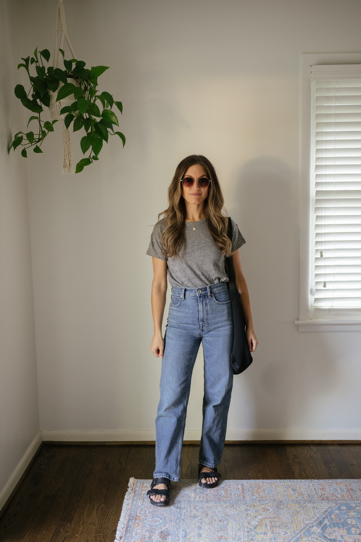 outfit idea for Seattle in the summer with a gray tee, mid-wash straight denim, and black Birkenstocks