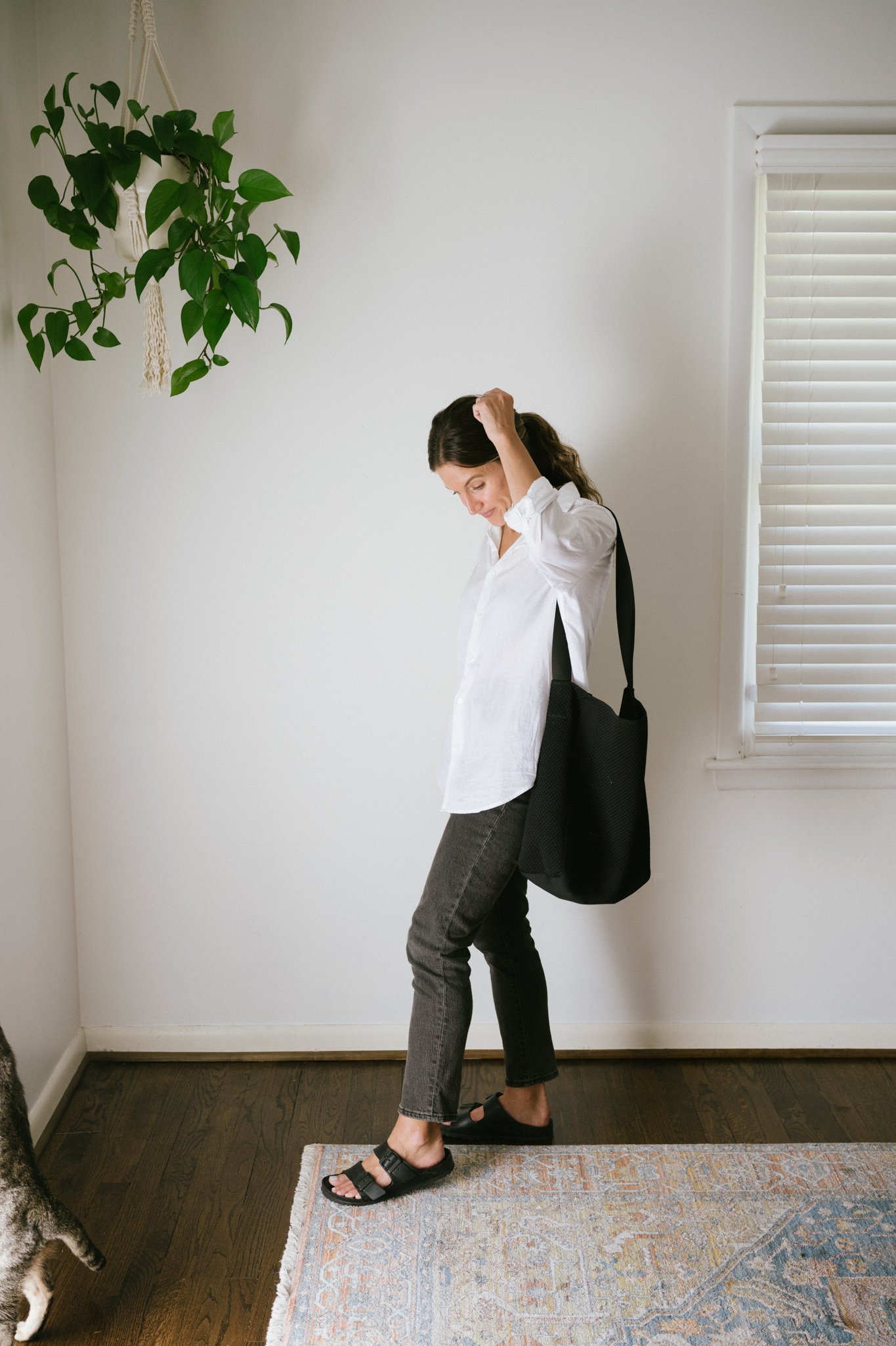 a white button down outfit with washed black denim and Birkenstocks