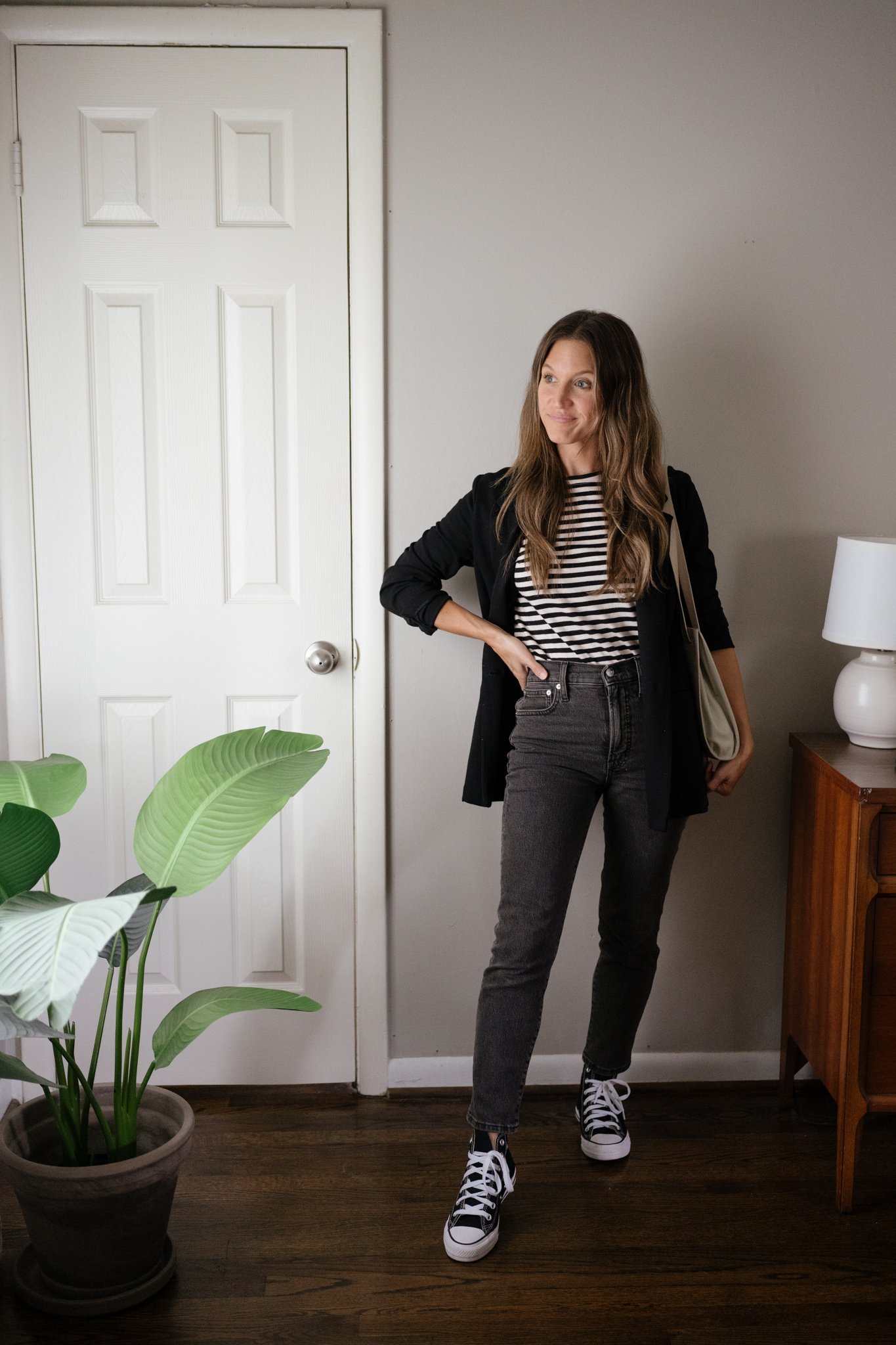 a neutral look for fall with a striped tee, black blazer, black denim, and black high top Converse