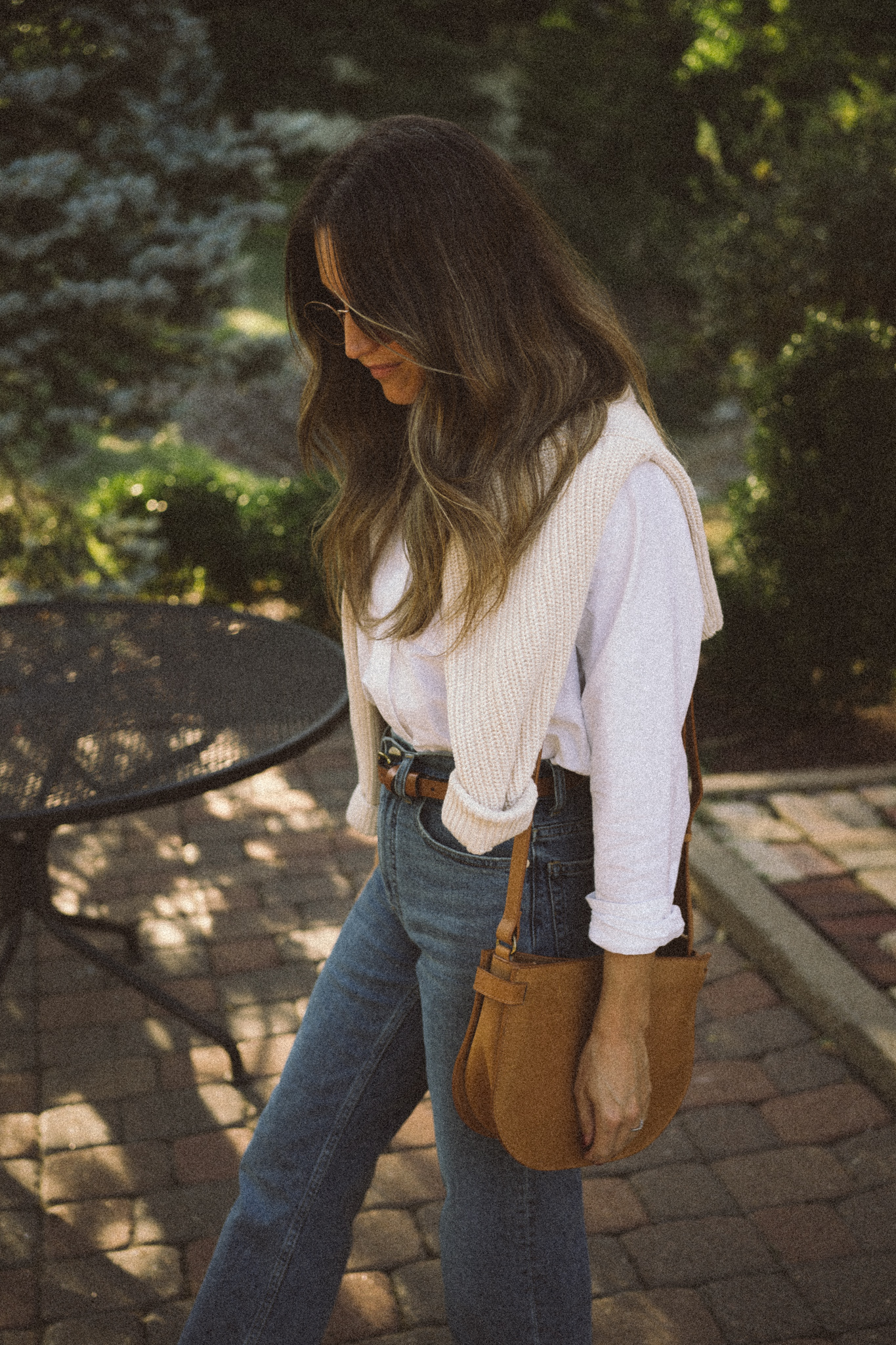 my fall uniform featuring a white button down, cream sweater over the shoulders, straight leg denim, and white sneakers