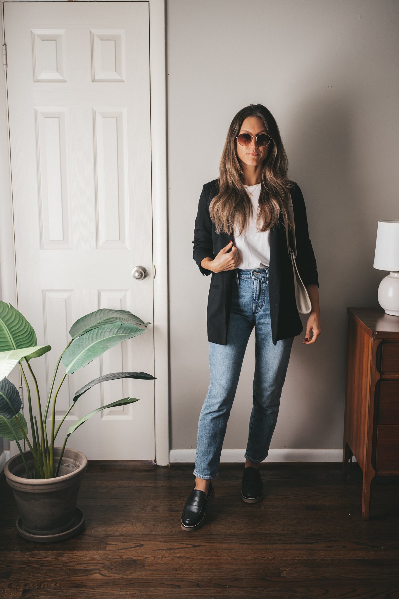 casual chic outfit idea with a white tee, black blazer, mid-wash denim, and chunky loafers