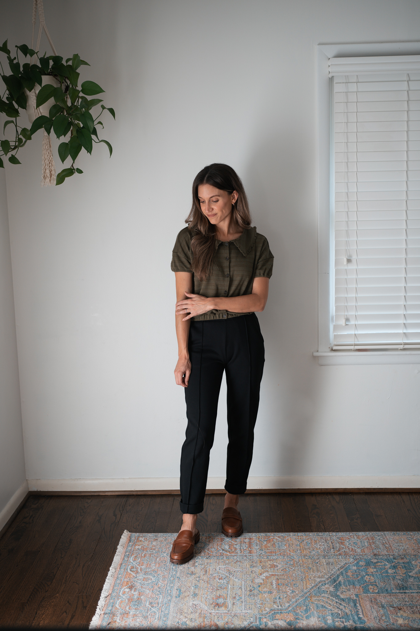 ways to style black pants with a green blouse with a peter pan collar and buttons down the front and brown loafer mules
