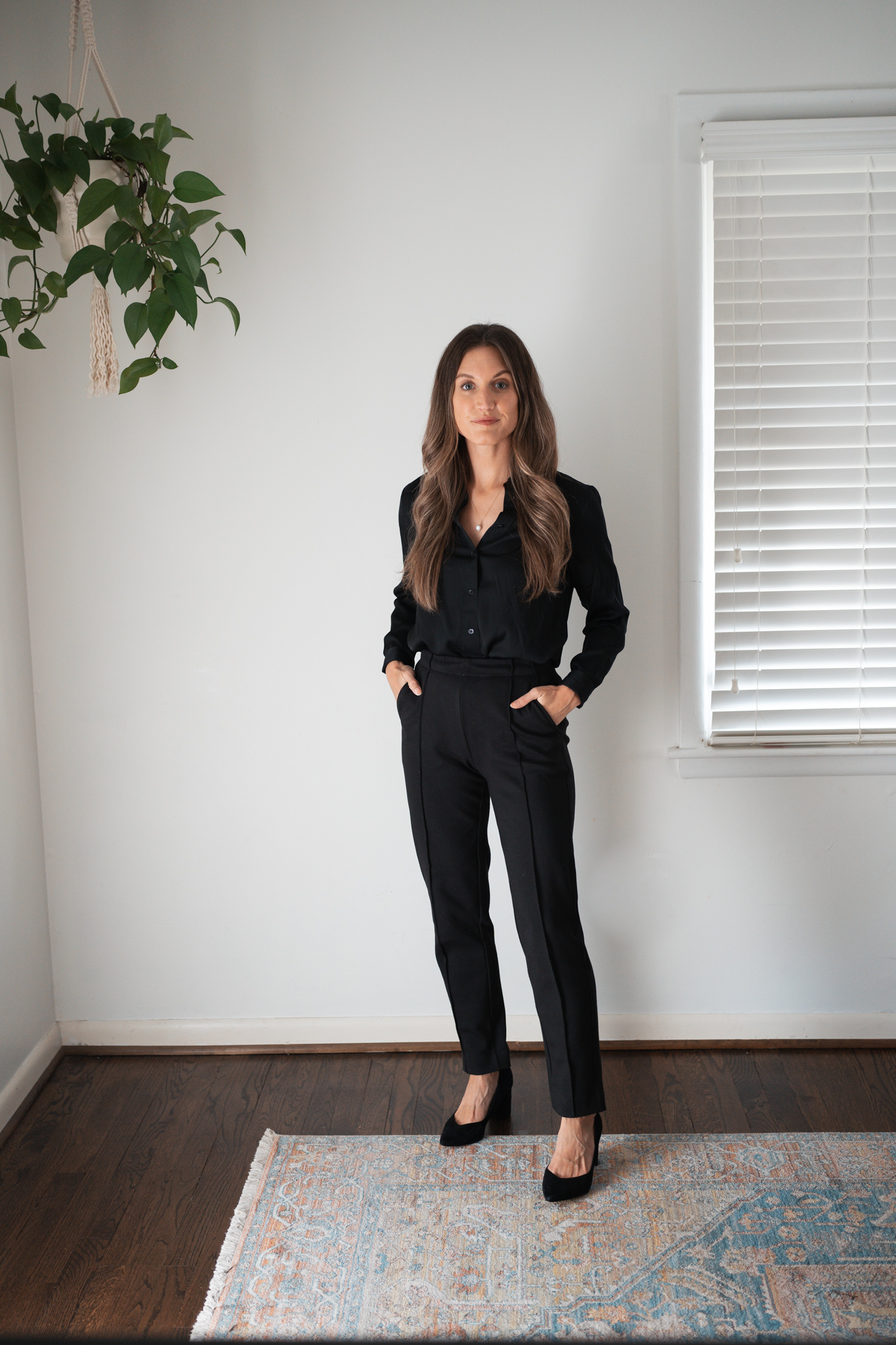 workwear outfit idea with black pants with a silk button down, and black pumps