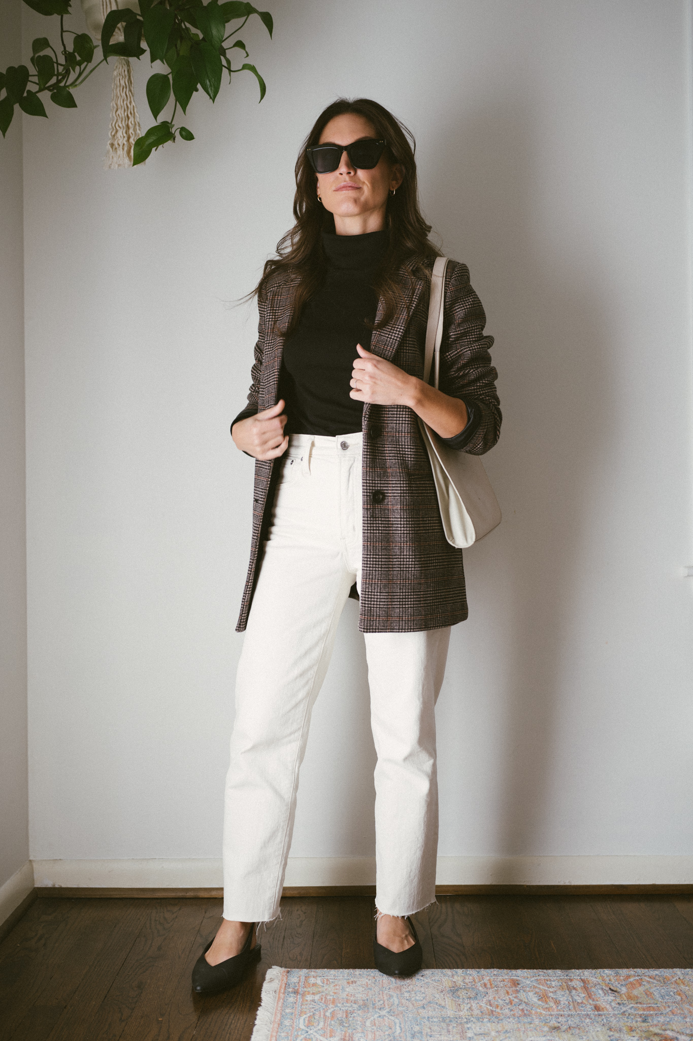 casual fall outfit featuring a black, turtleneck, plaid blazer, white denim, and black slingback flats