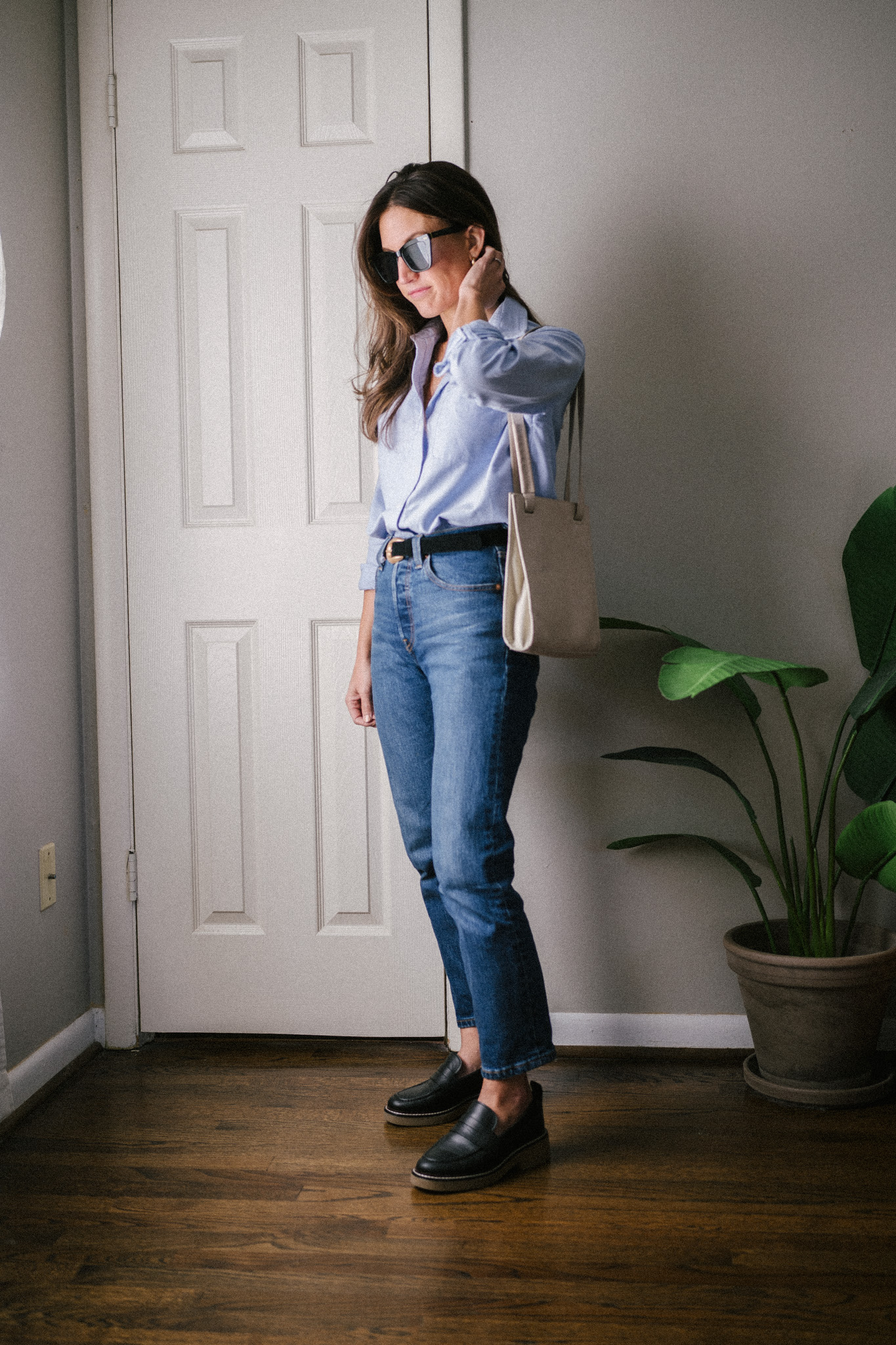 fall outfit idea with a light blue button down, dark wash denim, and chunky loafers