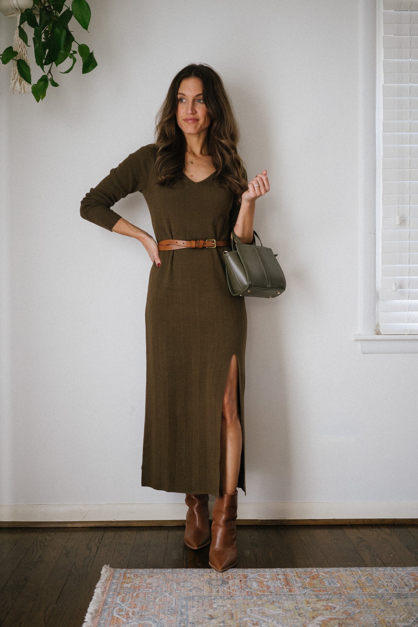 how to style a knit dress with a green knit dress, brown belt, and brown ankle boots