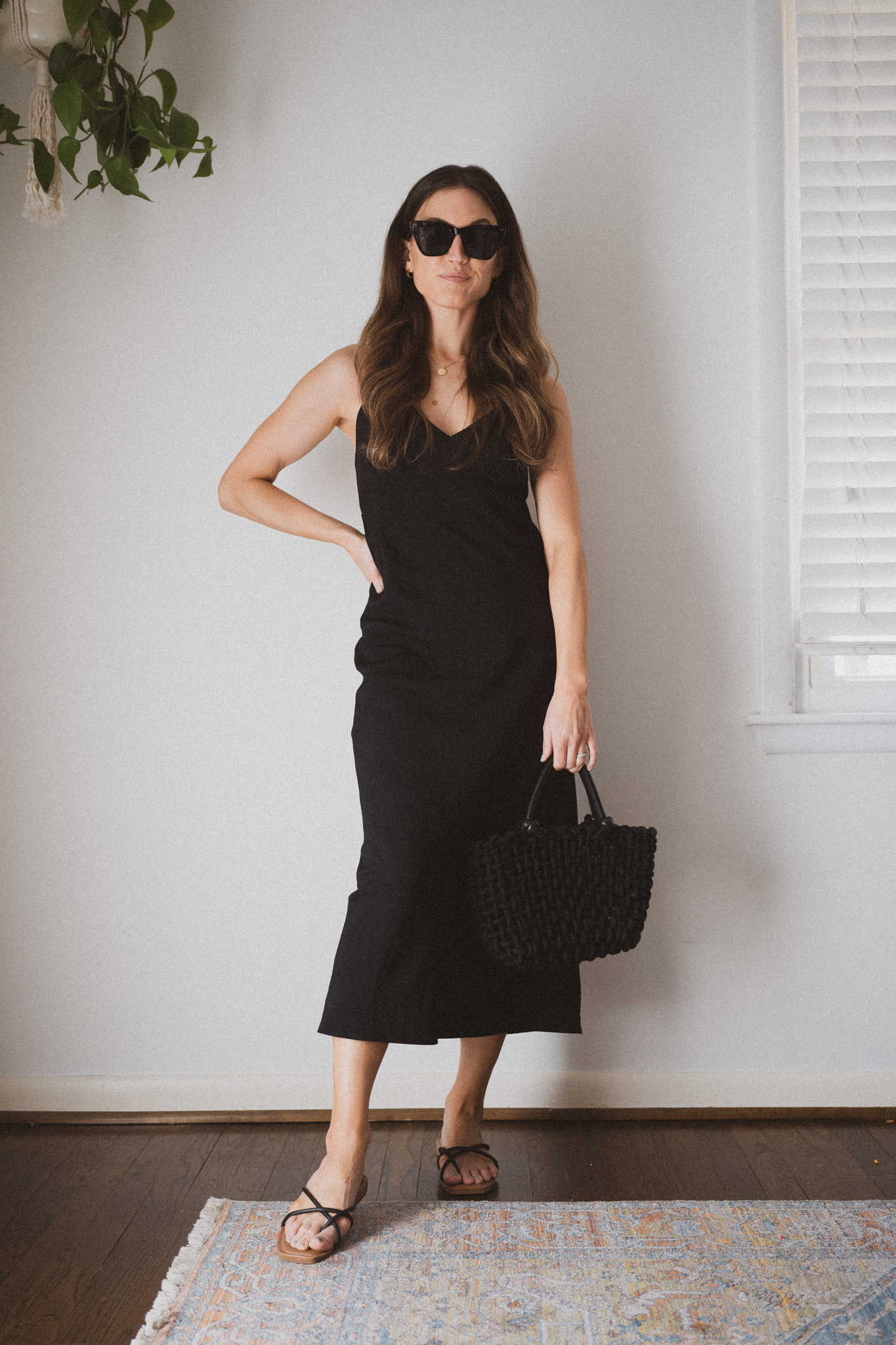 slip dress outfit with black strappy sandals and a woven bag