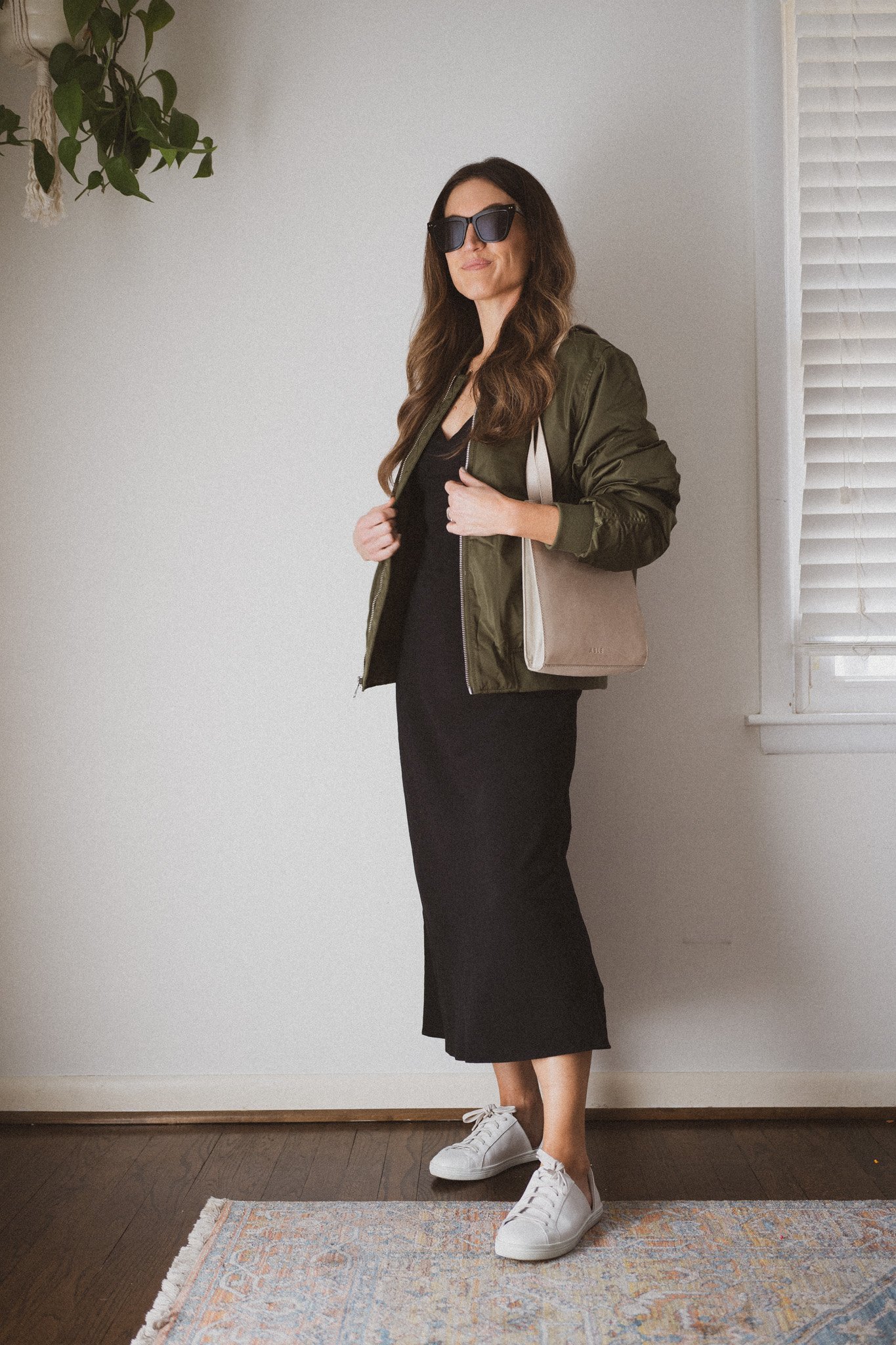 slip dress outfit with a green bomber jacket and white sneakers