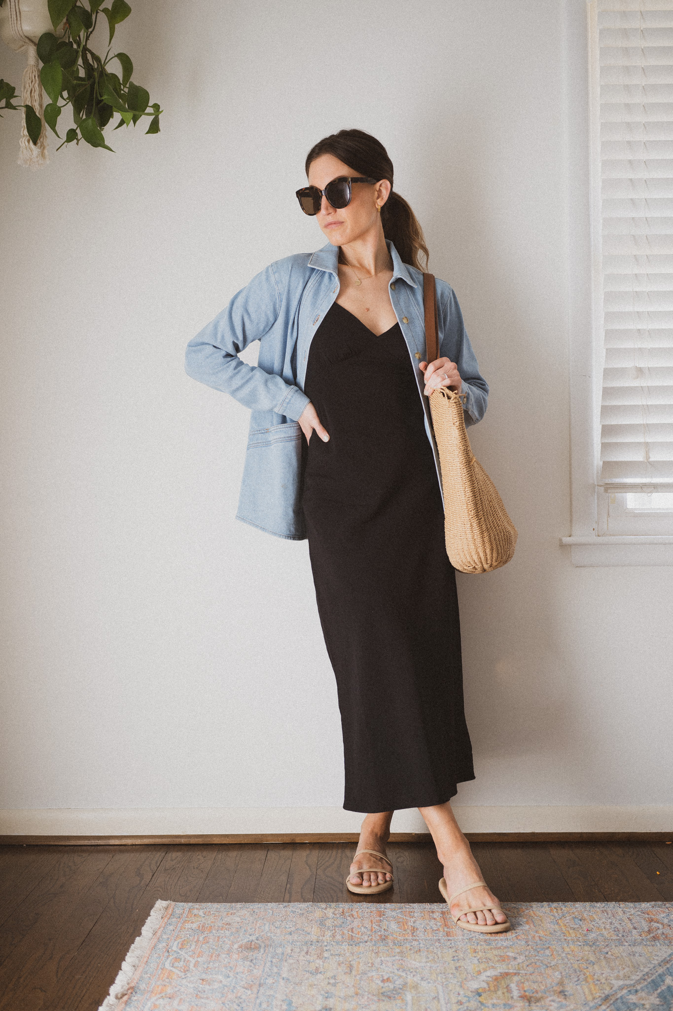 slip dress outfit with a denim jacket, nude sandals, and a woven tote bag