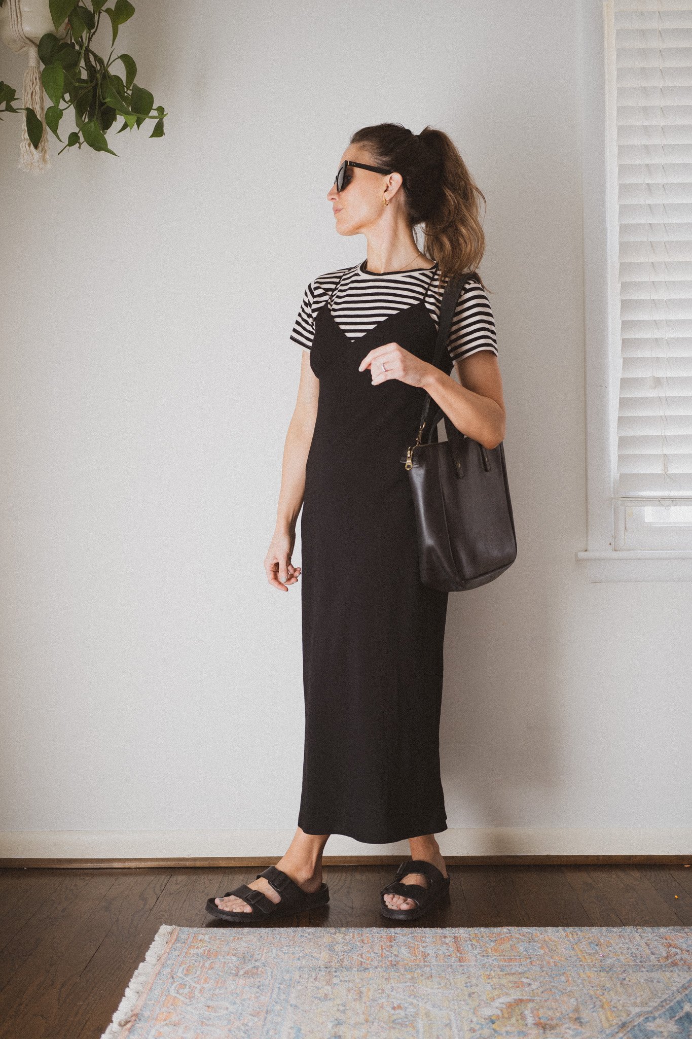 slip dress outfit with a striped tee layered underneath and black plastic birkenstocks