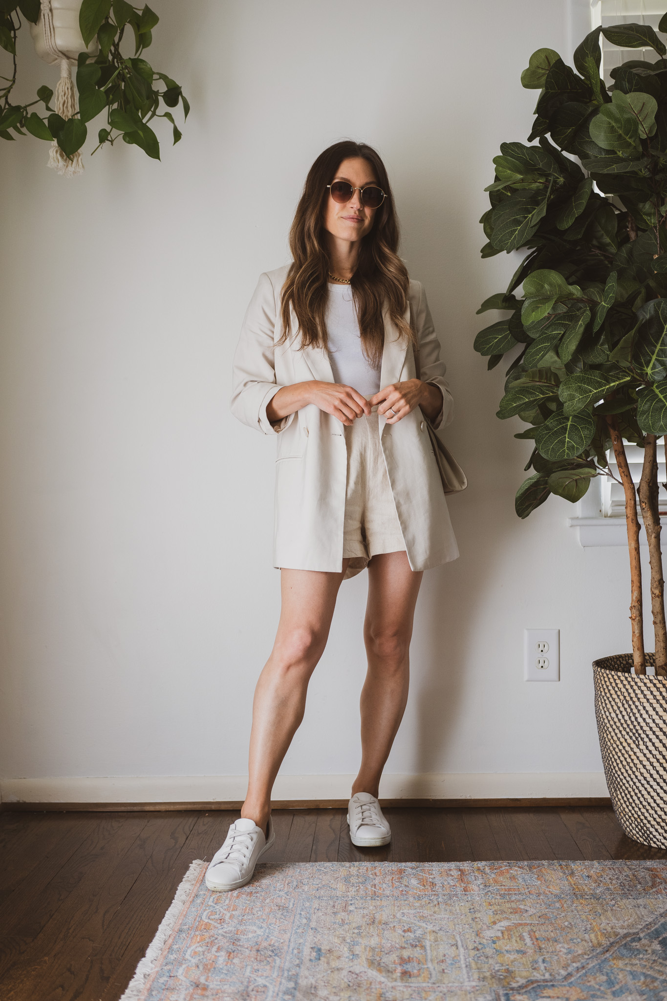 minimalist outfit with a white tank, beige blazer, beige linen shorts, and white sneakers
