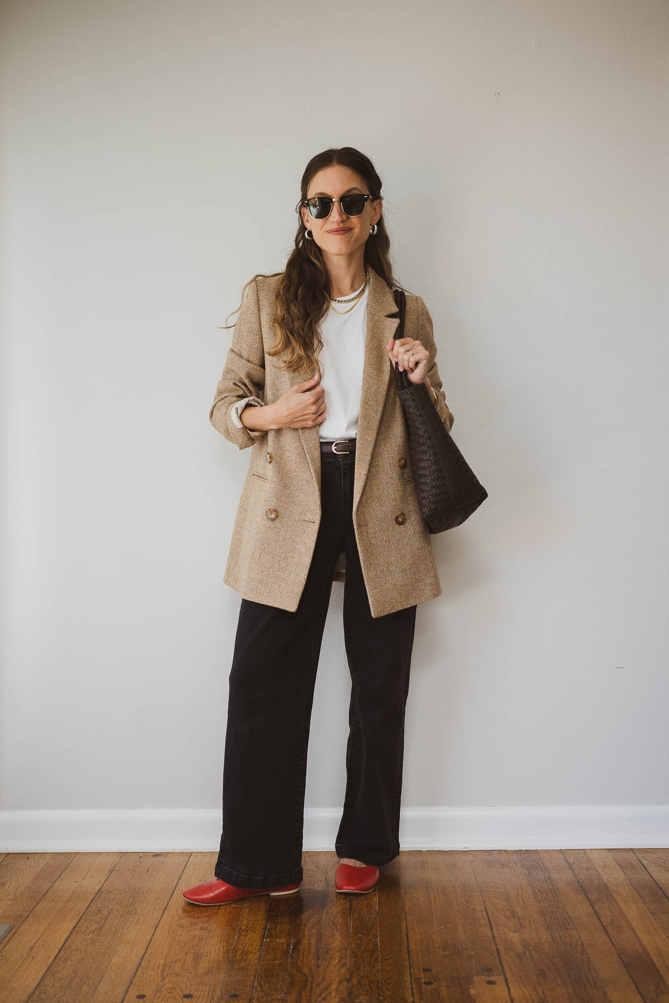 fall capsule wardrobe outfit with a white tee, tan wool blazer, black jeans, and red mary jane ballet flats