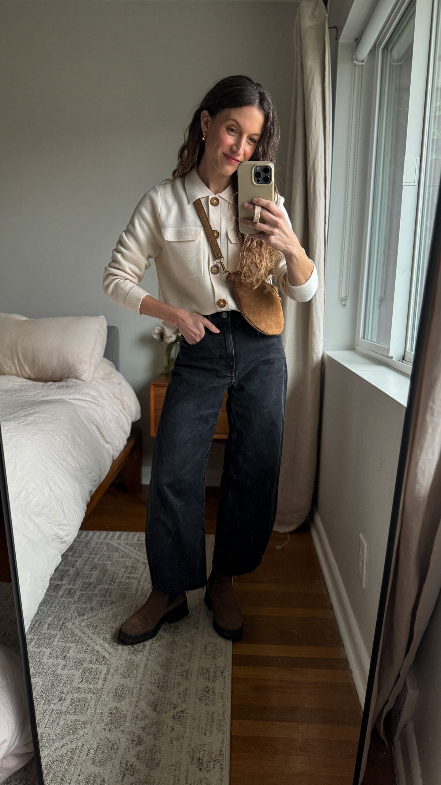 casual chic outfit idea with an ecru lady jacket, black barrel jeans, brown chunky chelsea boots, and a brown suede sling bag
