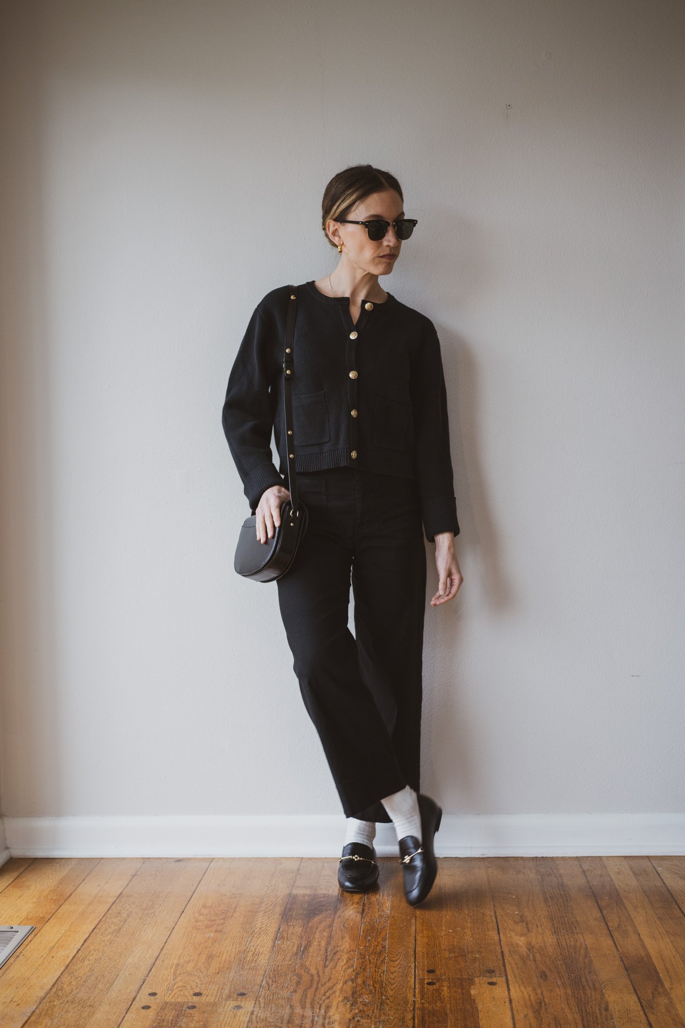 how to style loafers with a black lady jacket, black cropped pants, off-white ankle socks, and black loafers